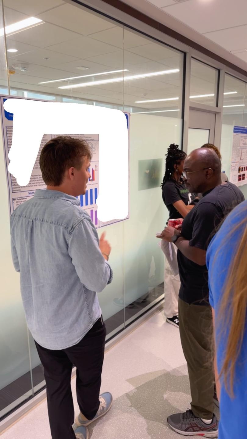 A student presents their poster to judges.
