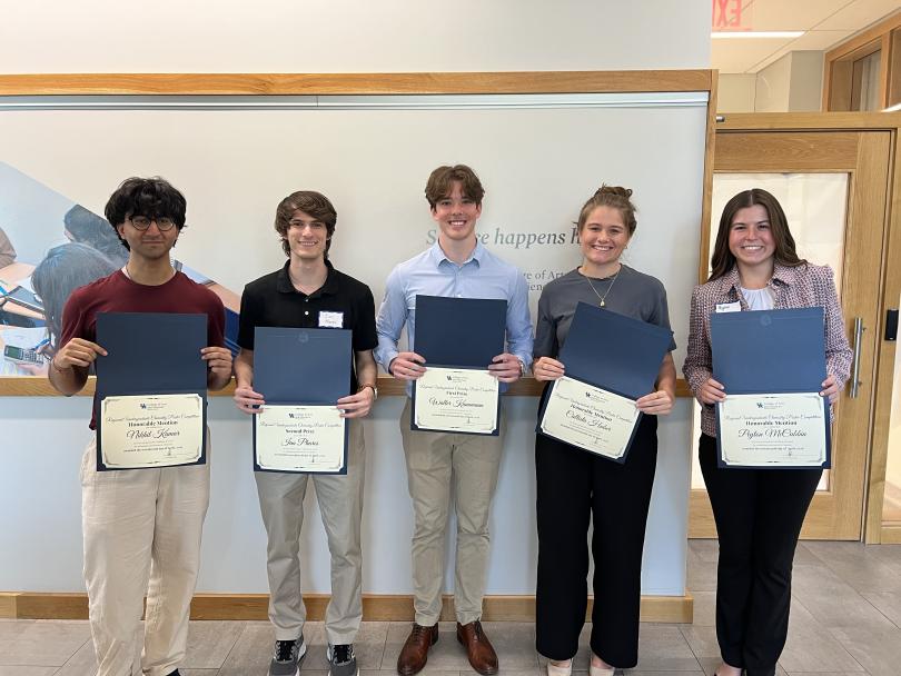 Five Undergraduate Poster Competition award recipients stand together holding certificates.