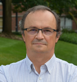 Color portrait of Alexander Laskin in front of trees.